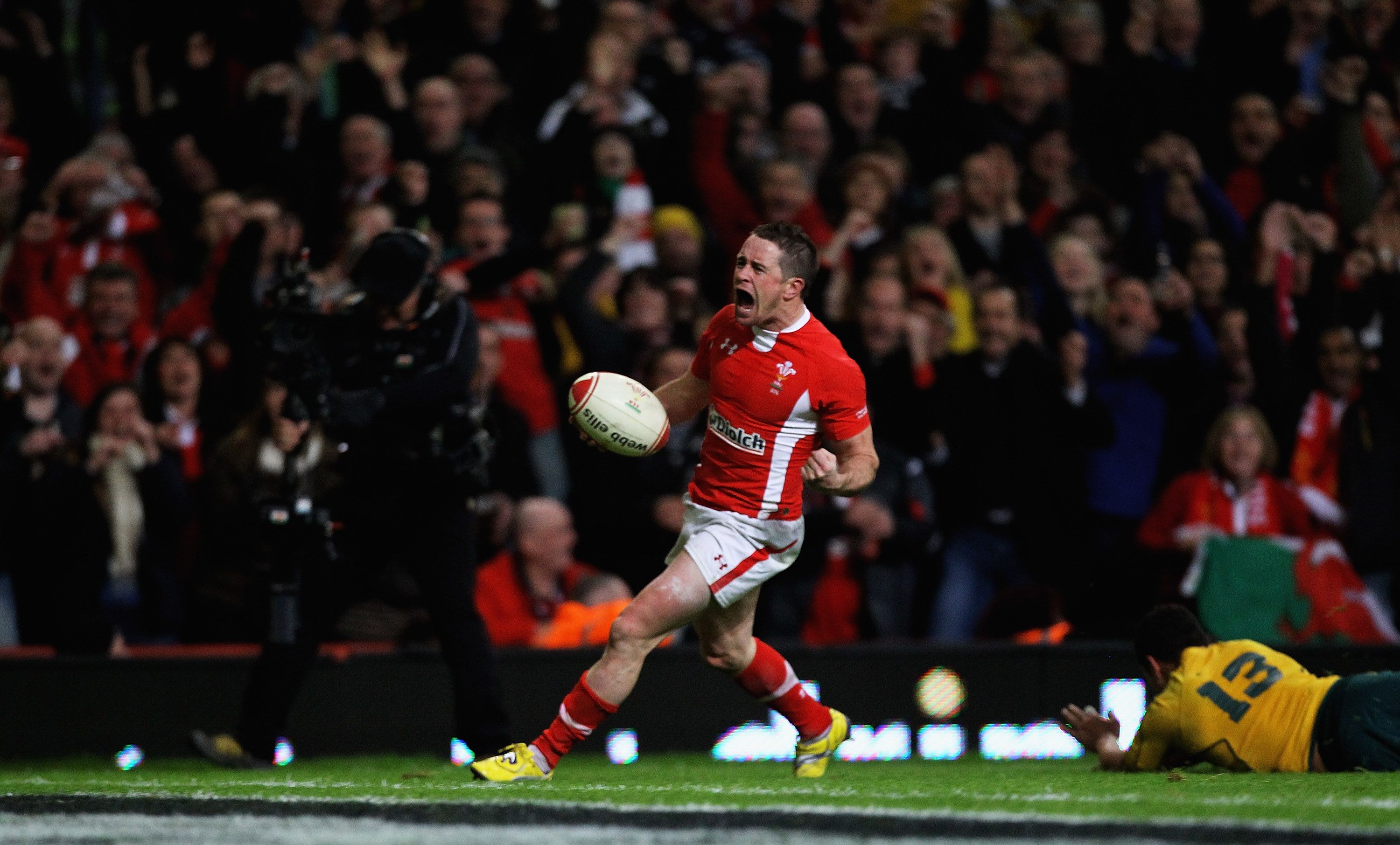 Shane Williams of Wales celebrates scoring a try d