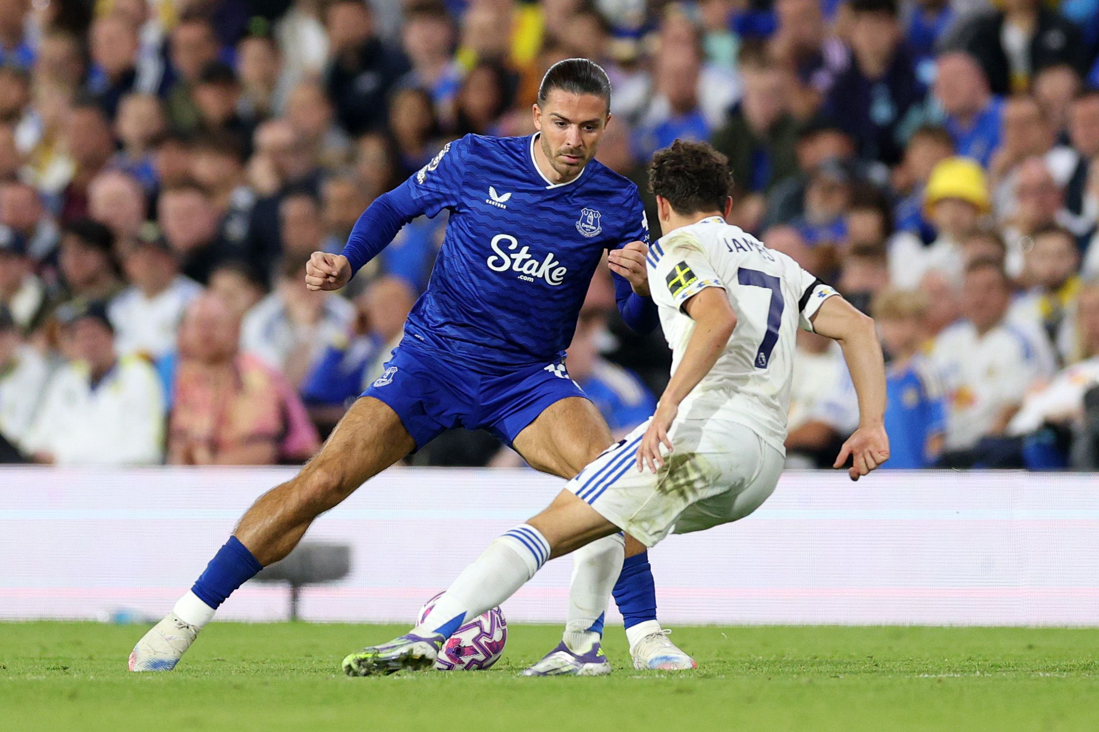  Jack Grealish of Everton runs with the ball whilst under pressure from Daniel James
