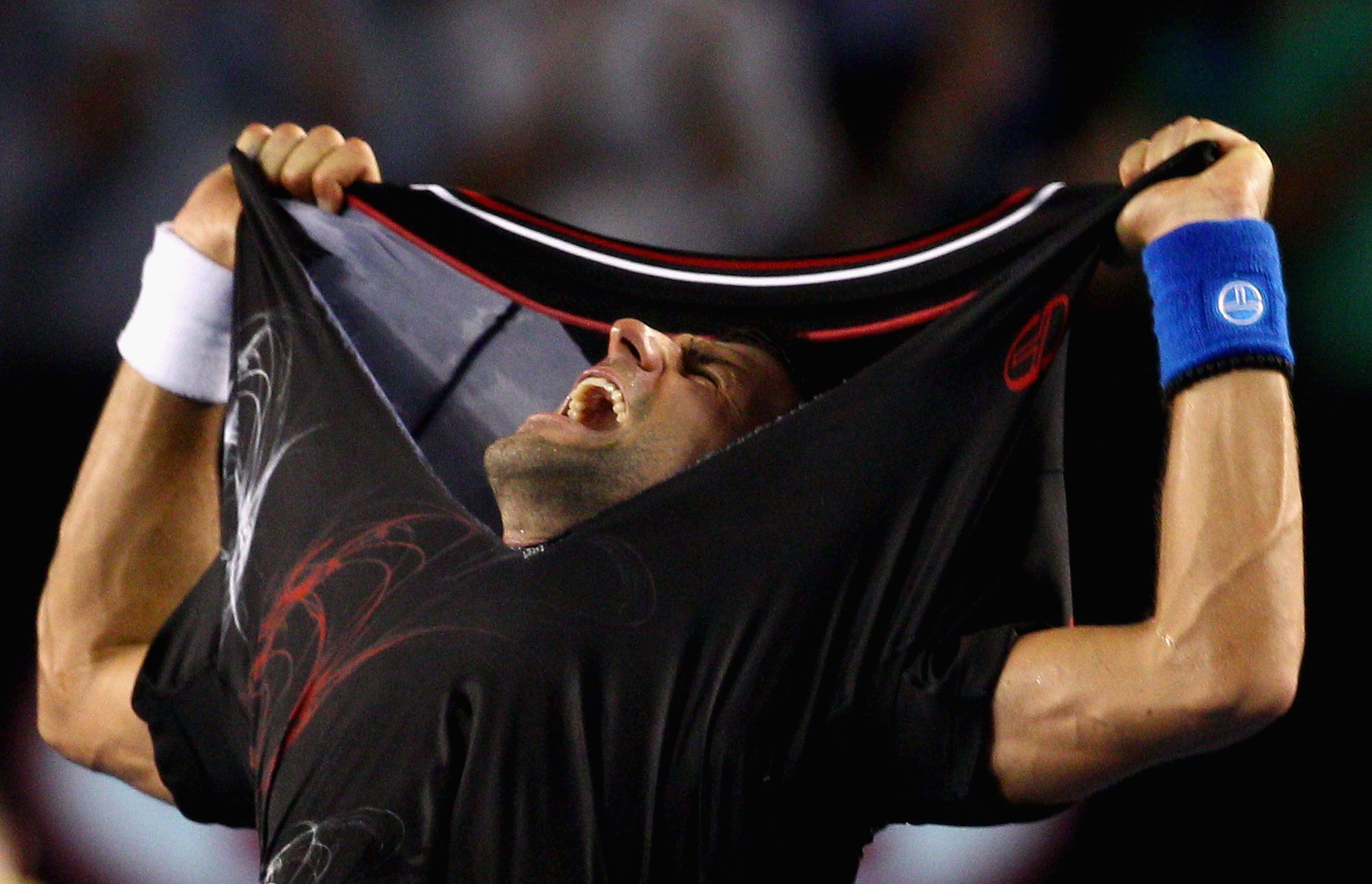 Novak Djokovic of Serbia rips his shirt off